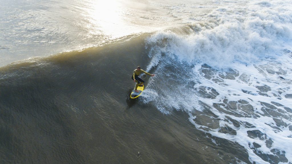 Surfer op golf, gaat down the line